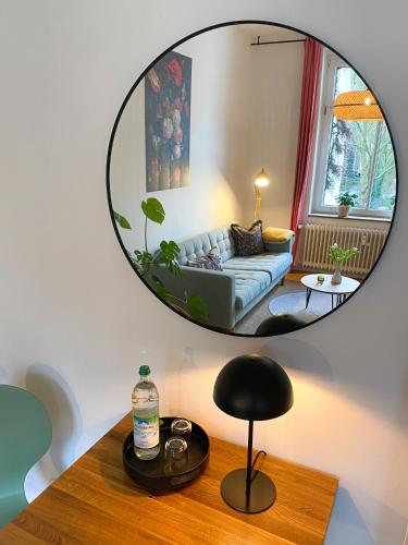a mirror reflecting a living room with a couch at Apartments "Am Rheinorange", Netflix & Prime in Duisburg