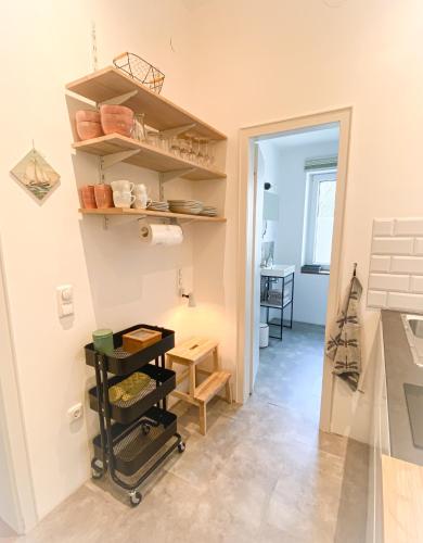 a room with shelves and a hallway with a table at Apartments "Am Rheinorange", Netflix & Prime in Duisburg