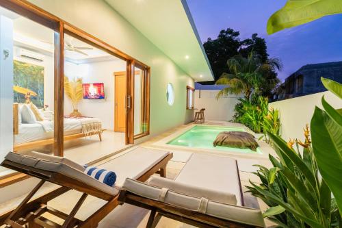 a living room with a pool and a bed and a room at Salthouse Villa Uluwatu in Uluwatu