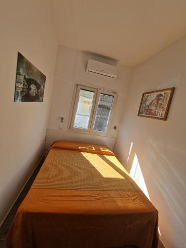 En eller flere senge i et værelse på Monolocale centrale Tortolì