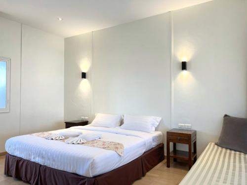 a hotel room with two beds and two tables at 3B Boutique Hotel in Chiang Mai