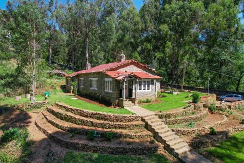 a small house with a garden in front of it at Springdale Villa in Kodaikānāl