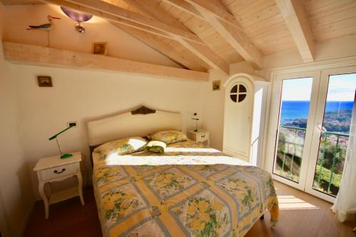 a bedroom with a bed and a large window at Villa Eos in Santa Margherita Ligure