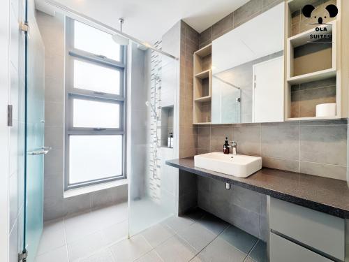 a bathroom with a sink and a glass shower at The Robertson Bukit Bintang in Kuala Lumpur
