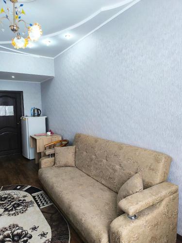 a living room with a couch and a table at Гостиничный комплекс Алтай in Lenīnogorsk