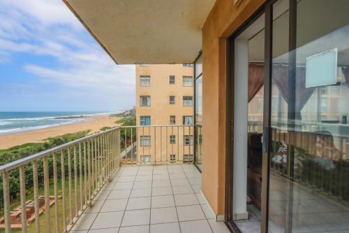 a balcony with a view of the beach at 504 Amazibu Holiday Flat- Paradise on the Beach in Amanzimtoti