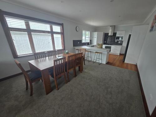 a kitchen and dining room with a table and chairs at Villa 191 in Masterton