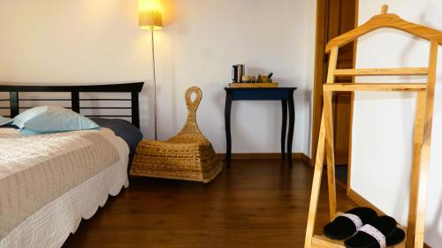a bedroom with a bed and a wooden ladder at Plaine et Colline Chambres et table d'hôtes Isère in Gillonnay