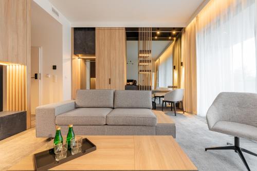 a living room with a couch and two bottles on a table at Shellter Hotel Resort & Spa in Rogowo