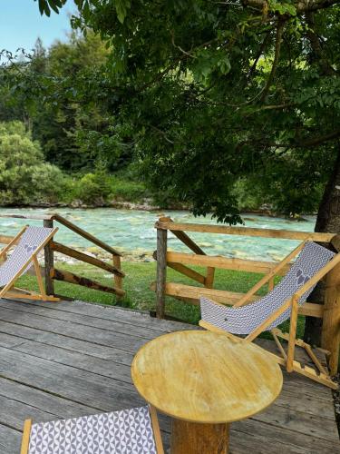 a wooden table and chairs on a wooden deck at Mountain View Apartments - Pr` Potovcn`k in Dovje