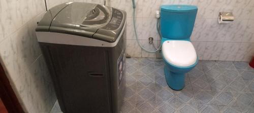 a small bathroom with a toilet and a trash can at Sharta Unawatuna Hostel in Unawatuna