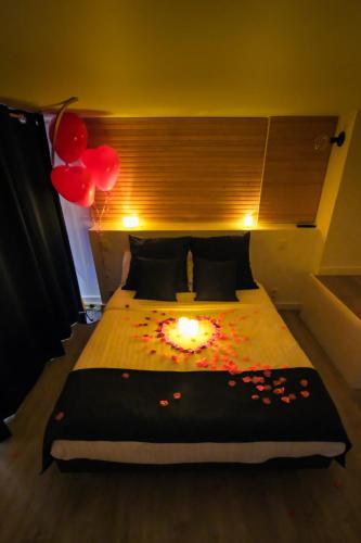 a bedroom with a bed with a candle on it at Villa Bono Jacuzzi & Spa in Saint-Laurent-du-Var