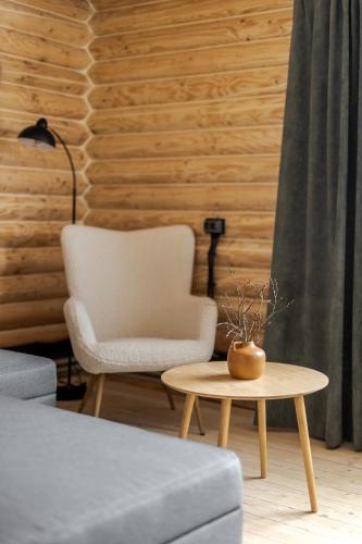 a living room with a chair and a coffee table at Gremi Hotel in Dragobrat