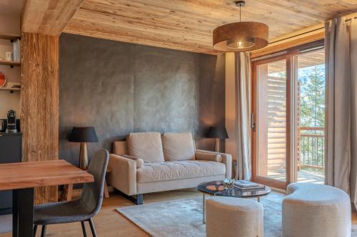 un salon avec un canapé et une table dans l'établissement Apartment Nuna, Méribel - by EMERALD STAY, à Les Allues