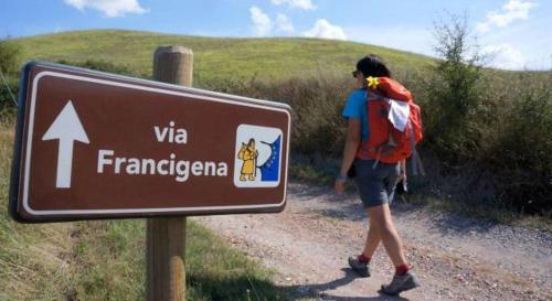 a woman walking down a dirt road next to a sign at CASABONA1910 bed&breakfast in Vercelli