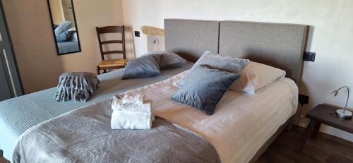 a bed with two pillows and a bag on it at Agriturismo La Pina in Tarzo
