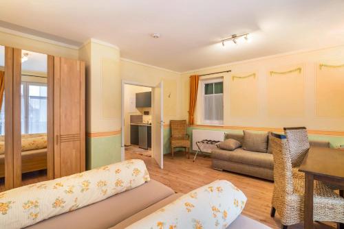 a living room with a couch and a table at SCHUSTERjunge Aparthotel in Sasbachwalden