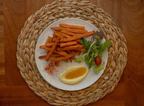 a plate with french fries and a lemon wedge at Zoella Earth Suites in Preveza