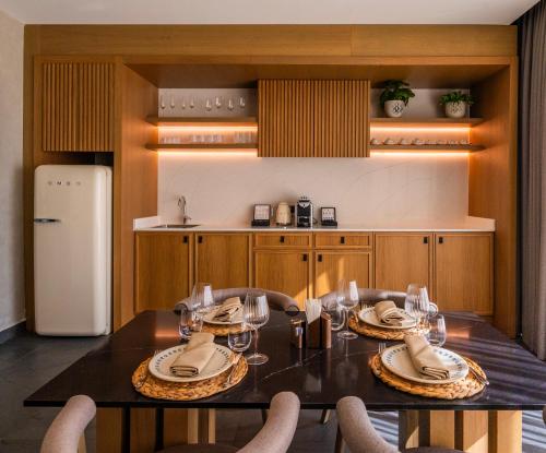a dining room with a table and chairs and a refrigerator at Ethno Belek in Belek