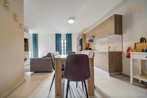 a kitchen and dining room with a table and chairs at Penthouse in Mosta with city views & terrace by 360 Estates in Mosta