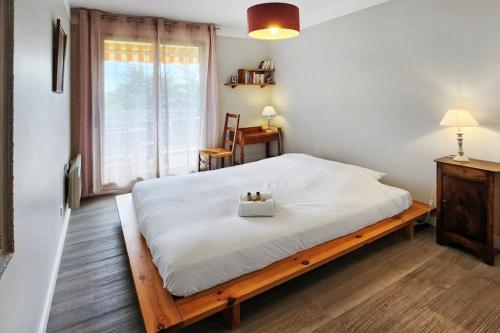 a bedroom with a bed with a wooden frame and a window at Terrace Caluire in Caluire-et-Cuire
