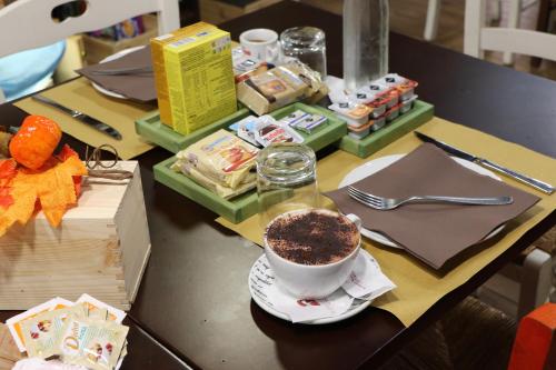 a table with a cup of coffee and a bowl of food at Le stanze di Vino Rosso in Nocera Superiore