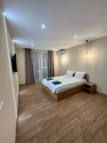 a bedroom with a bed and a television in it at Music Flats in Sofia