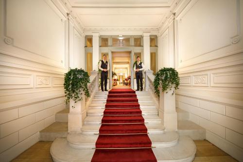 two men in suits standing on a red carpet at Hotel Imperial - Liburnia in Opatija