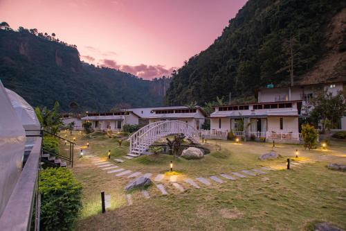 a view of a resort with lights in a field at Harness Zipline And Adventure Resort in Kusma