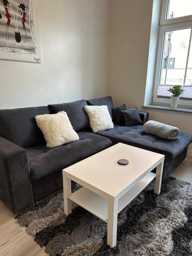 a living room with a couch and a coffee table at I'M Apartment SILVER I centrum free parking in Bolesławiec