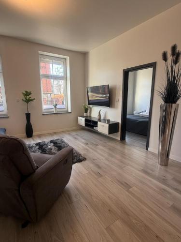 a living room with a couch and a mirror at I'M Apartment SILVER I centrum free parking in Bolesławiec