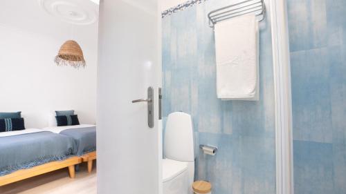 a bathroom with a shower and a bed and a toilet at Amaro Oasis by LovelyStay in Funchal