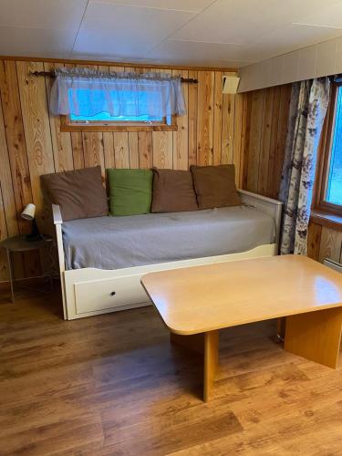 a living room with a couch and a table at Aurora House under the mountain in Tromsø