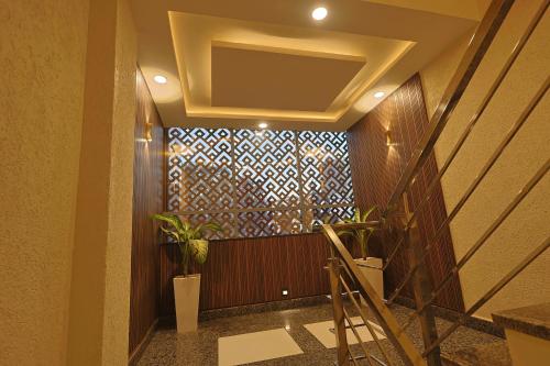 a hallway with a staircase with a wall with a pattern at AJMER TERRACES Hotel in Ajmer