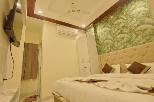a bedroom with a bed and a wall mural at AJMER TERRACES Hotel in Ajmer