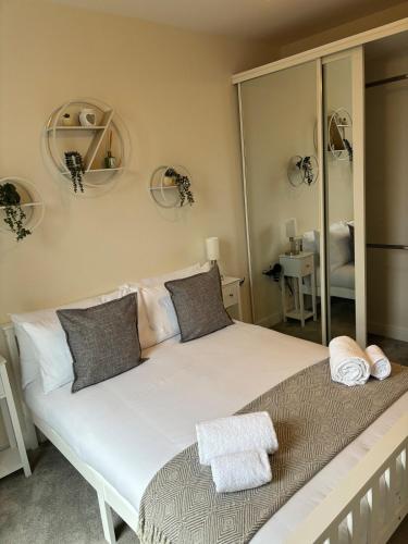 a bedroom with a large bed with a large mirror at Modern spacious apartment in Addlestone in Addlestone