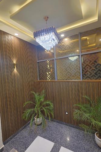 a room with a chandelier and plants in it at AJMER TERRACES Hotel in Ajmer