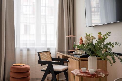 a room with a table and a chair and a window at Colette - LoftAffair Collection in Warsaw