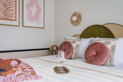 a bedroom with a bed with a wine glass on it at Colette - LoftAffair Collection in Warsaw