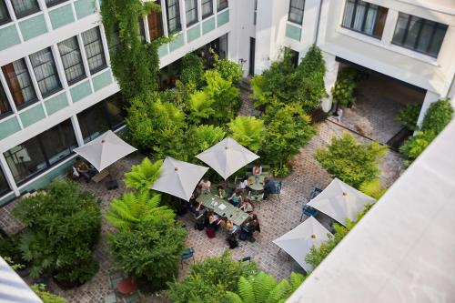 an overhead view of a courtyard with tables and umbrellas at Le Grand Quartier in Paris