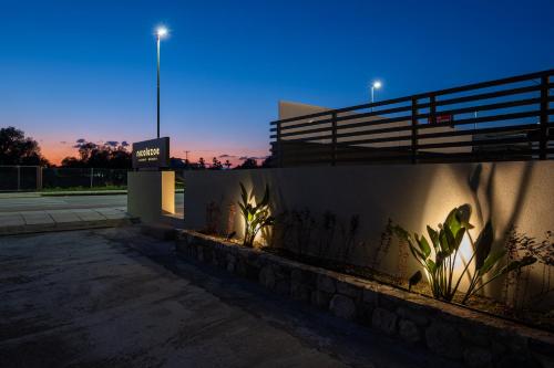 a building with a fence and plants in front of it at Beach Luxury Homes - Zoe in Lampi