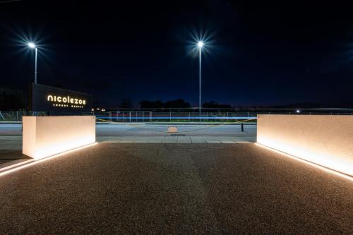 a parking lot at night with street lights at Beach Luxury Homes - Zoe in Lampi