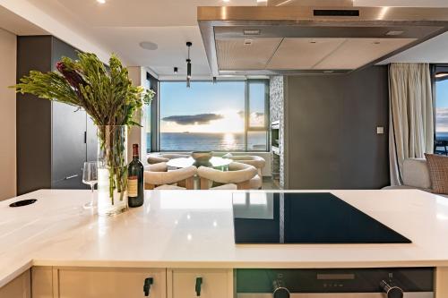 a kitchen with a view of the ocean at Luxury Beachfront Penthouse, Blouberg- 3 Bedroom in Bloubergstrand