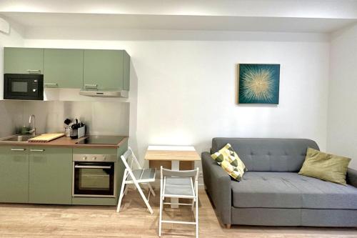 un salon avec un canapé et une cuisine dans l'établissement Studio NEUF proche METRO, à Villeurbanne