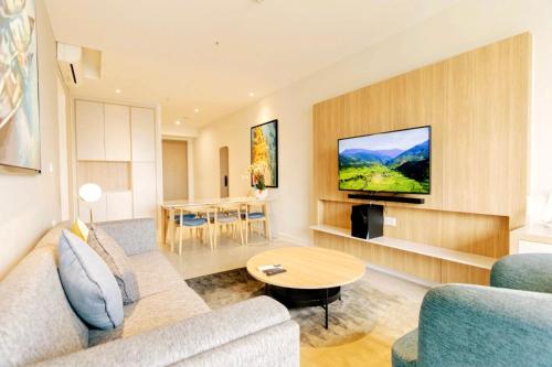 a living room with a couch and a table at Grand Zenity D1 Residence in Ho Chi Minh City