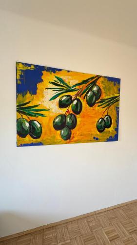 a painting of a bunch of olives hanging on a wall at Apartment 7 im Herzen von Linz in Linz