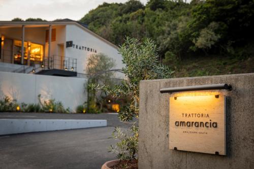 a sign that reads tritriica amazonapa in front of a building at amarancia cottage hugging nature house in Minamiawaji