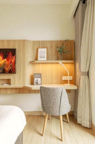 a bedroom with a bed and a desk and a chair at Grand Zenity D1 Residence in Ho Chi Minh City