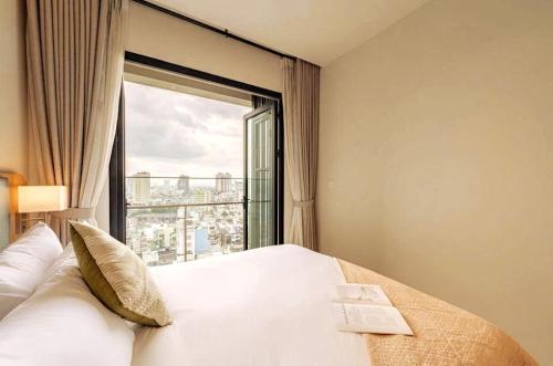 a bedroom with a bed and a large window at Grand Zenity D1 Residence in Ho Chi Minh City