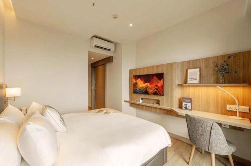 a bedroom with a large white bed and a desk at Grand Zenity D1 Residence in Ho Chi Minh City
